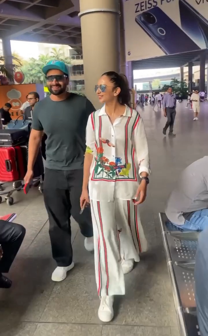 White floral-striped Butterfly Lane co-ord set styled with sunglasses for travel