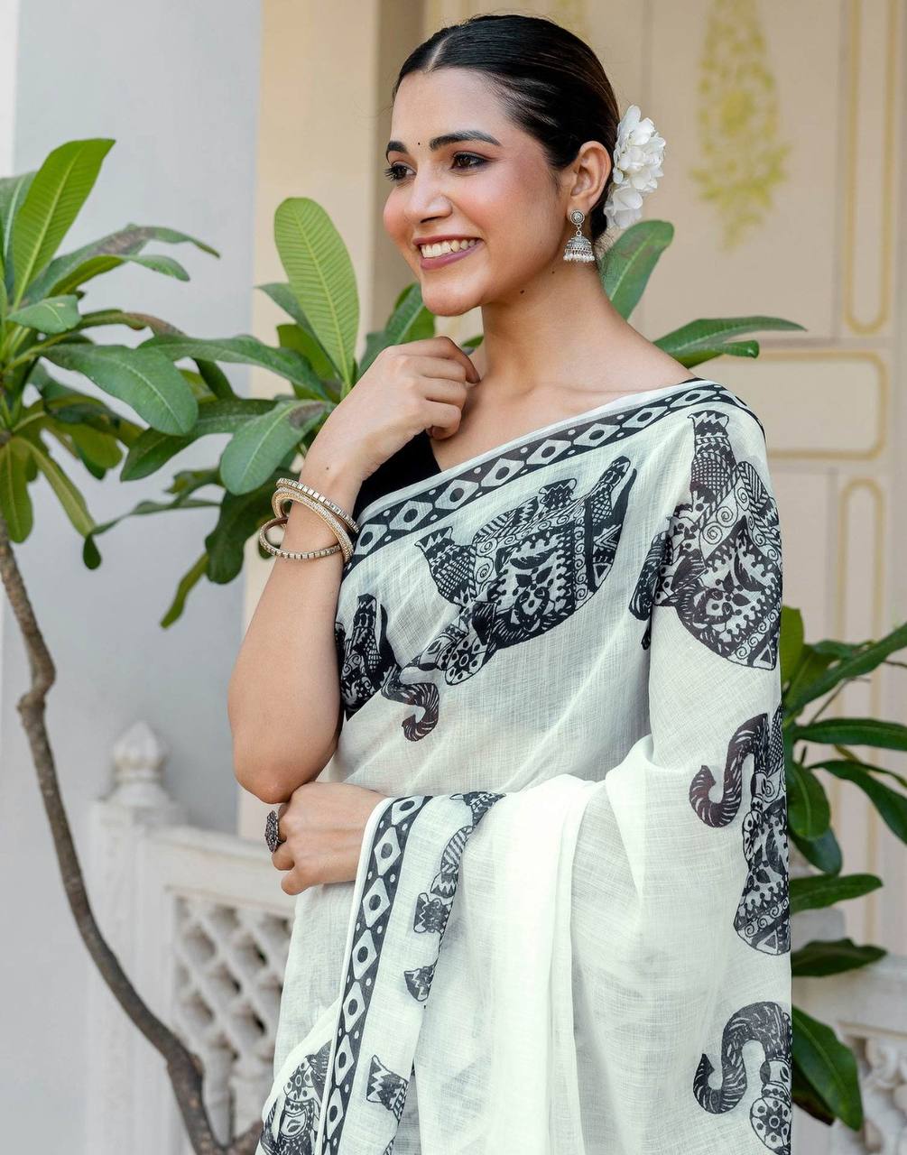 linen digital printed saree with elegant elephant motifs & stylish latkans
